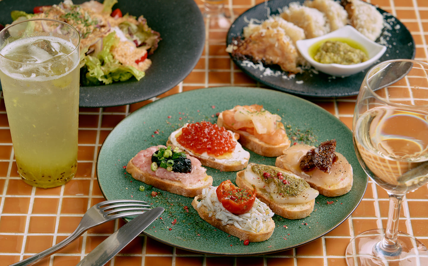 オレンジタイルのテーブルに華やかな料理が映える