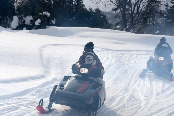 起伏のある3kmのコースを疾走する「スノーモービル」大人1回10,000円。スタッフがレベルに応じて先導してくれる
